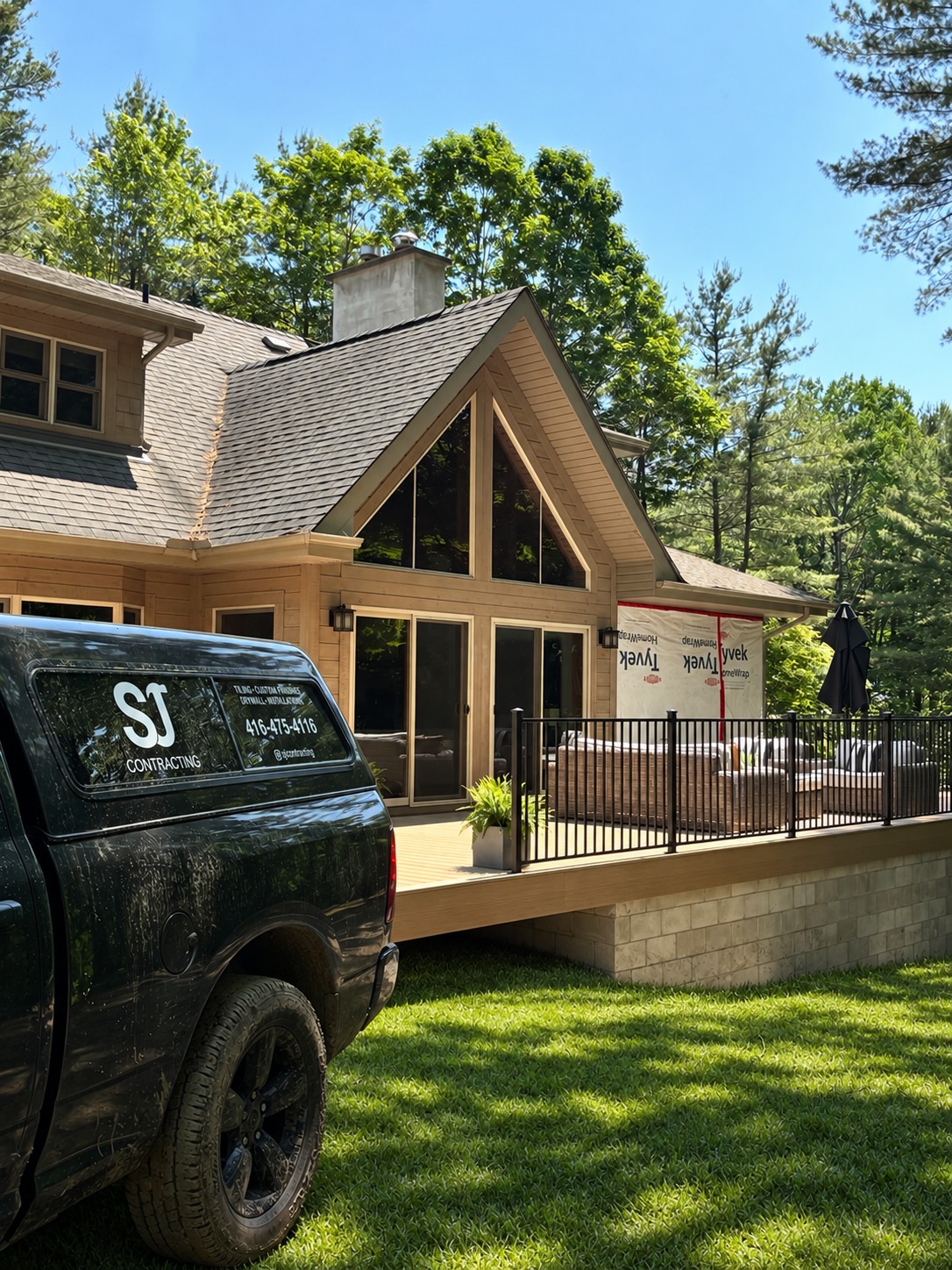 Home addition and deck with black railing