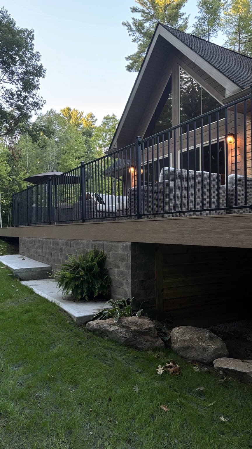 Black railing, composite decking and a connection to the landscape.