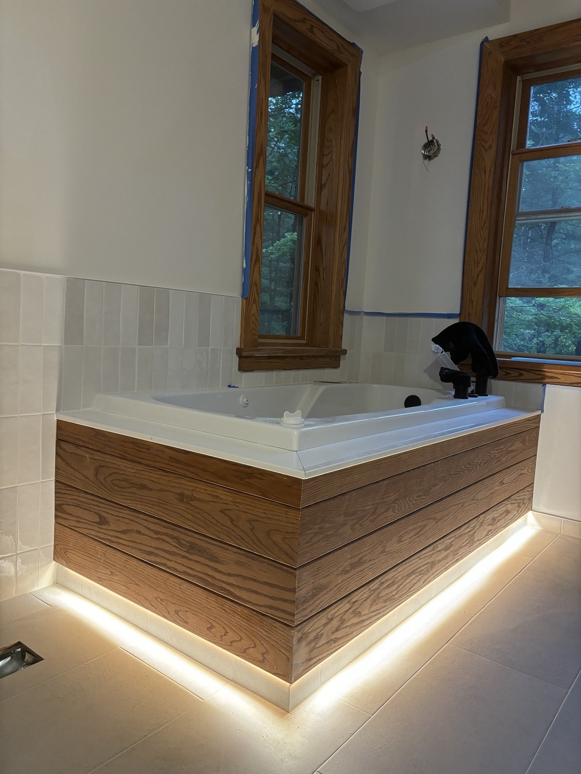 Wood-clad tub surround with lighting beneath. Work in progress.